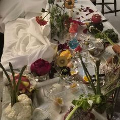 the table is covered with flowers and other things to eat for dinner or as an appetizer