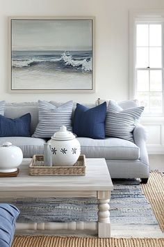 a living room filled with furniture and pillows on top of a wooden table in front of a window