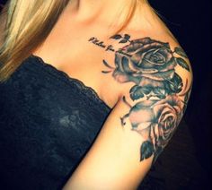 a woman with a rose tattoo on her arm and shoulder is looking at the camera