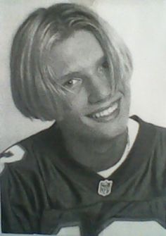 a drawing of a man with blonde hair and wearing a football uniform smiling at the camera