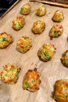 some broccoli and cheese muffins are sitting on a baking sheet, ready to go into the oven