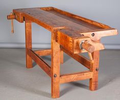 a work bench made out of wood with wheels on the top and one wheel at the bottom