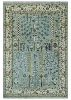 a blue rug with an intricate design on the front and back side, in various colors