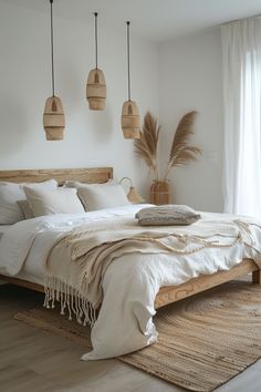 a large bed sitting in a bedroom next to two hanging lights and a rug on top of a wooden floor