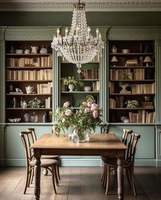 a dining room table with chairs and a chandelier