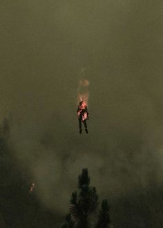 a man flying through the air while riding a skateboard on top of a hill