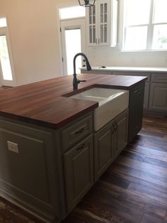 a kitchen with an island and sink in it