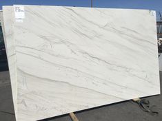 a white marble slab sitting on top of a parking lot