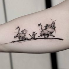 the lion king and the mouse queen tattoo on the left inner arm, right forearm