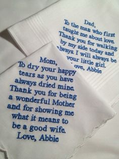 two handkerchiefs with embroidered words on them, one saying mom and the other saying i love you