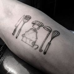 a tattoo with utensils on the leg