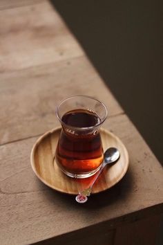 a cup of tea sitting on top of a wooden table