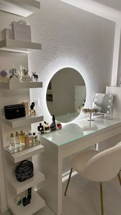 a white desk topped with a mirror and lots of bottles