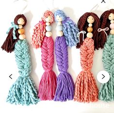 four different colors of yarn with wooden beads on them, and one is made to look like mermaid tails