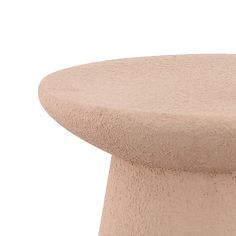 a close up view of the top of a table with a circular base and round legs