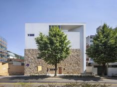 the building is made out of stone and has two trees on each side of it