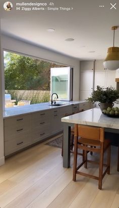 a large kitchen with an island in the middle and lots of counter space on one side