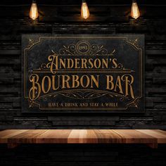 a wooden table sitting in front of a sign that says anderson's bourbon bar