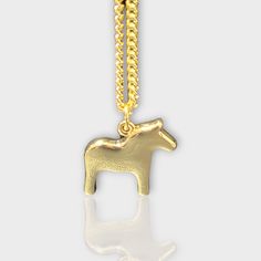 The Dala Horse Necklace by Anna Viktoria Gold Horse Design Pendant Necklace, Gold Pendant Necklace With Horse Design, Metal Horse Design Jewelry Gift, Gold Plated Pendant Necklaces Cadmium-free, Gold Plated Pendant Necklace, Cadmium-free, Elegant Gold Jewelry With Horse Design, Horse Design Pendant Jewelry Gift, Nickel-free Yellow Gold Metal Necklace, Swedish Symbols