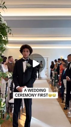 a young man in a tuxedo is standing at the end of a wedding ceremony