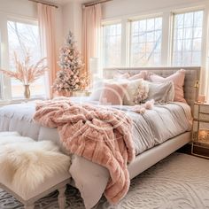 a bedroom decorated for christmas with pink and white decorations on the bed, windows, and rugs