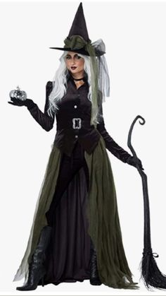 a woman dressed as a witch holding a broom and wearing a black dress with white hair