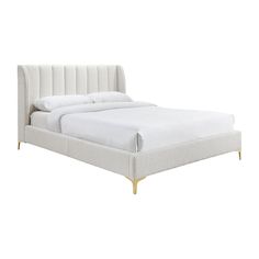 a bed with white linens and gold legs