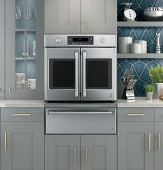 a kitchen with stainless steel appliances and blue backsplash