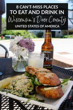 a plate with a sandwich and salad on it next to a bottle of beer that says 8 can't miss places to eat and drink in wisconsin's deer country united states of america