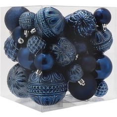 a bunch of blue ornaments in a clear box