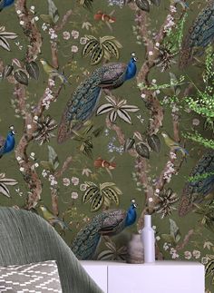 peacocks and flowers on a green wallpaper in a living room