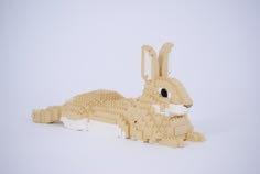 a lego rabbit laying down in the snow