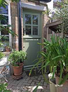 the front door to a house with potted plants