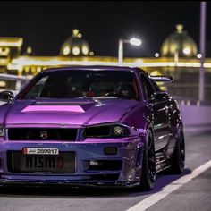 a purple car is parked on the street