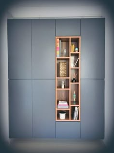 a bookshelf in the corner of a room with several shelves on each side