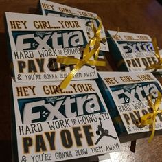 four business cards tied with yellow ribbon on top of a wooden table next to each other