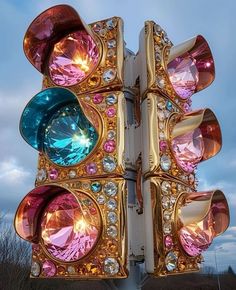 a close up of a traffic light with many different colored lights on it's sides