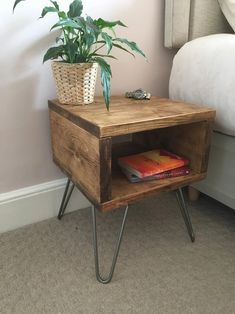 a wooden side table with a potted plant on top and books in the bottom