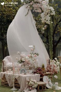 an outdoor wedding setup with flowers and candles