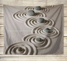 a towel with rocks arranged in the shape of spirals on top of each other