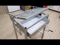 a stainless steel table on wheels in a room