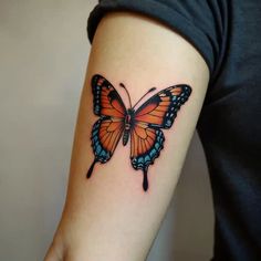 a woman's arm with a butterfly tattoo on the left side of her arm