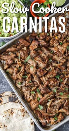 slow cooker carnitas in a baking pan with tortillas on the side