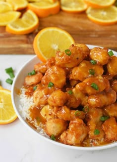 a white bowl filled with orange chicken and rice