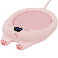 a pink cat shaped alarm clock with paws on the front and paw prints on the back