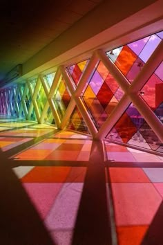 colorful stained glass windows are shown in this photo, with the light coming through them