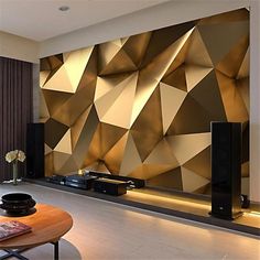 modern living room with gold geometric wallpaper and large television on the stand in front of it