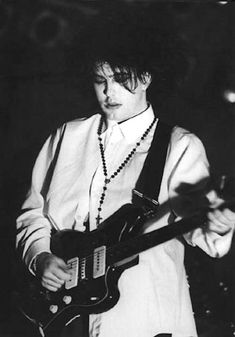 black and white photograph of a man playing an electric guitar