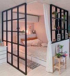 the bedroom is decorated in white and has glass doors that open up to reveal a bed