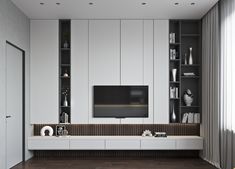 a modern living room with white walls and wooden flooring, built in shelving units